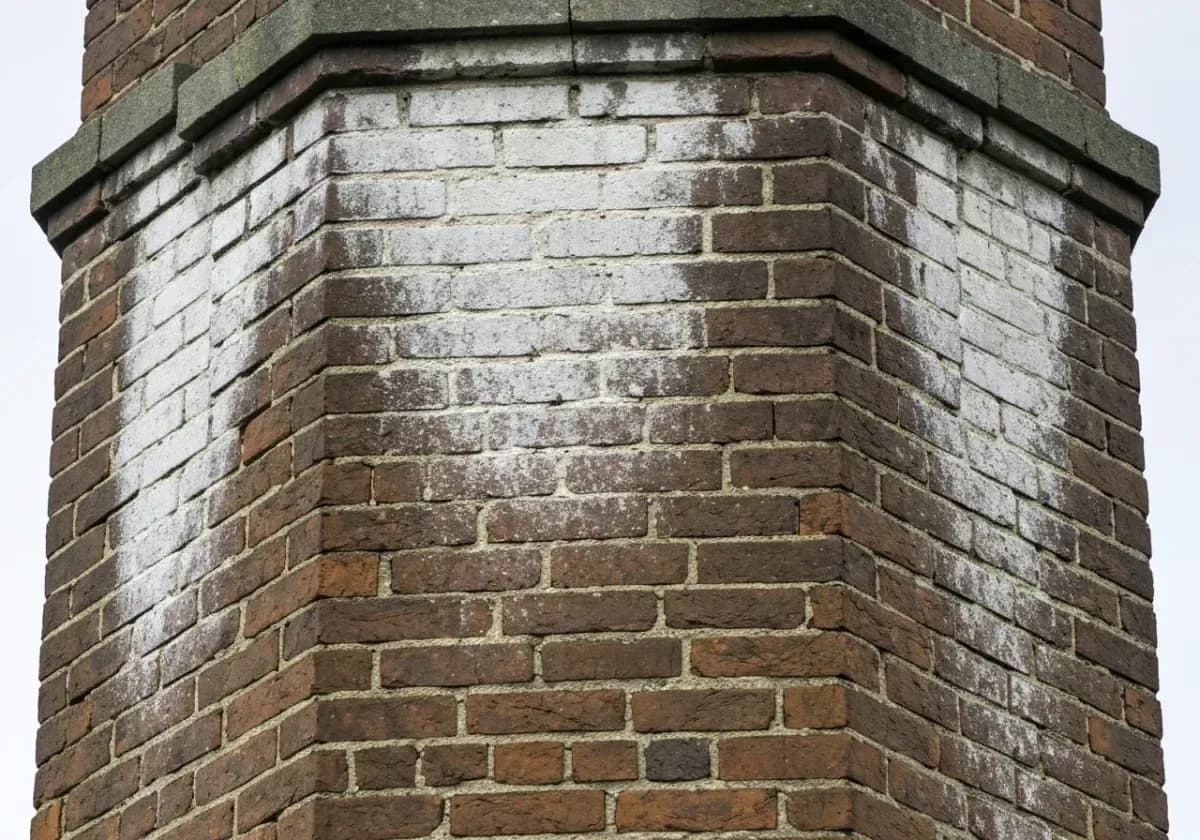Before — chimney waterproofing: Rain-saturated brick treated with a breathable repellent that sheds water, not vapor.