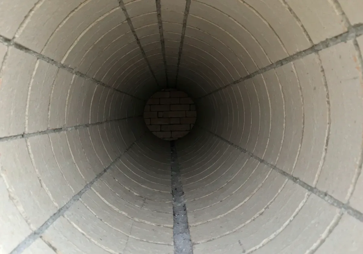 After — creosote removal: Stage 3 glazed creosote taken down to clean flue walls — the fire fuel removed.